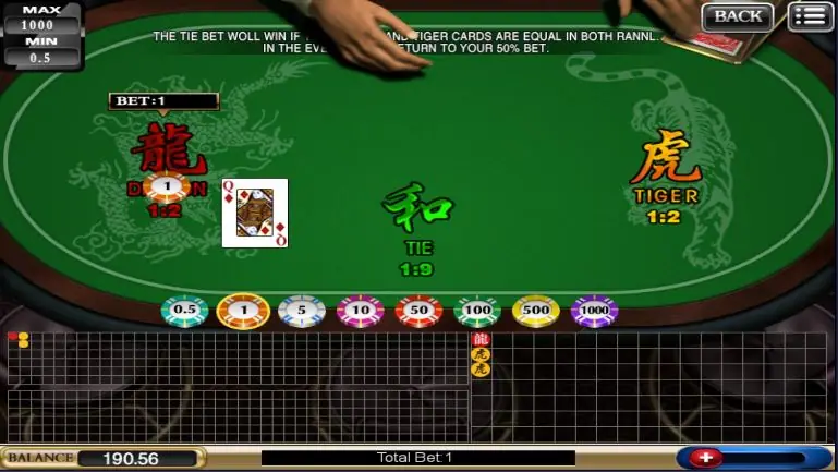The dealer's hand sliding a card across the Dragon Tiger table
